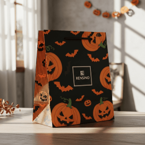 Sac-cadeau en papier noir avec motif de citrouille Jack-o’-Lantern, adapté pour les cadeaux d'Halloween et l'affichage en magasin