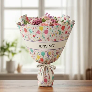 Papier d'emballage coloré sur le thème de la fête avec ruban, adapté pour l'emballage de cadeaux ou de vente au détail