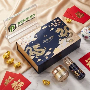 Caja rígida de papel azul marino Clé de Peau Beauté con patrón de dragón y floral, adecuada para empaques de cosméticos, servicio OEM/ODM disponible