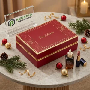 Scatola regalo rossa e dorata con testo stampato “Estée Lauder” e motivo decorativo, adatta per regali, cosmetici o imballaggi al dettaglio, servizio OEM/ODM disponibile