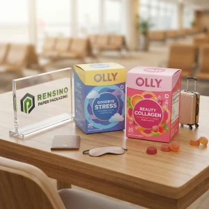 Boîte d'emballage en papier rose et bleu avec logos imprimés et motifs colorés, adaptée pour les cadeaux, le commerce de détail ou l'emballage alimentaire, design personnalisé disponible