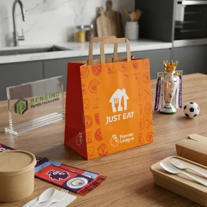 Borsa regalo di carta arancione con logo stampato JUST EAT e Premier League, adatta per imballaggio alimentare o vendita al dettaglio, servizio OEM/ODM disponibile