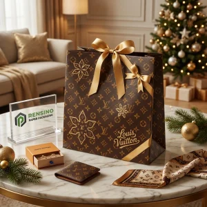 Empaque de bolsa de papel marrón con cinta dorada y patrón de copo de nieve, adecuado para empaques de regalo o joyería, impresión de logo personalizada disponible