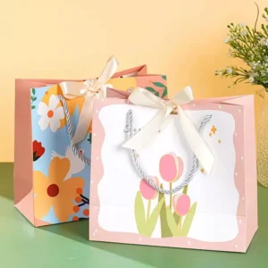 Black Matte Kraft Paper Gift Bags with Gold Foil Logo and Ribbon Handles for Boutiques
