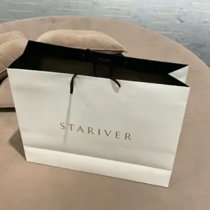 Black Paper Gift Bag with Custom Gold Hot-Stamped Logo, Twisted Paper Rope Handles and Black Interior for Apparel Packaging