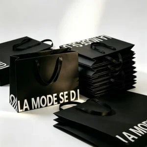 Black Paper Gift Bags with White Letter Print and Satin Ribbon Handles for Apparel Store Packaging