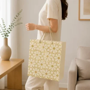 Cream Paper Gift Bag with Gold Floral Foil Pattern and Twisted Rope Handle for Wedding and Beauty Packaging