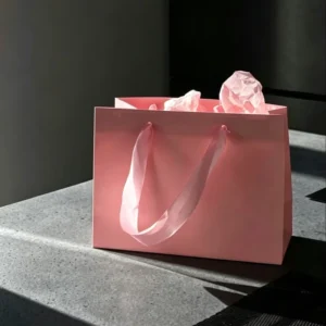 Custom Logo Light Pink Shiny Paper Carrier Bag with Satin Ribbon Handles for Cosmetic Jewelry Gift Packaging
