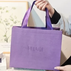 Custom Matte Light Pink Paper Bag with Gold Hot-Stamped Logo, Twisted Paper Rope Handles, and Detachable Gold Satin Bow for Beauty and Jewelry