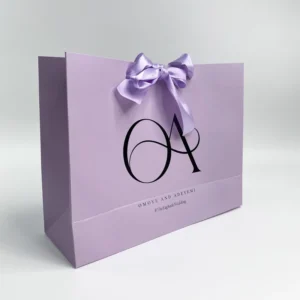 Custom Printed Purple Kraft Paper Gift Bags with Cardboard Construction, Ribbon Handles, and Logo