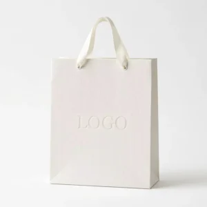 Elegant Plain Texture Carry Bag with Reinforced Handle Custom Logo White Cardboard Bag for Imagine Centers and Wedding Packaging