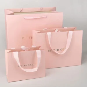 White Paper Shopping Bag with Gold Foil Stamped Logo and Rope Handles for Cosmetics and Jewelry