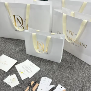 White Paper Shopping Gift Bag with Custom Gold Foil Logo and Ribbon Handle for Jewelry and Fashion Retail