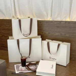 Custom Cream White Paper Tote Bag with Wide Ribbon Handles for Boutique Clothing and Shoes Packaging