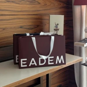 Custom Logo Gloss-Laminated Wine Red Paper Carrier Bag with White Ribbon Handles for Hair Salon, Beauty, and Apparel Packaging