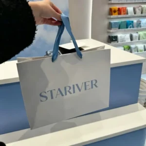 Custom Printed Brand Logo White Coated Paper Carrier Bag Light Blue Satin Ribbon for Cosmetic Store Retail Packaging