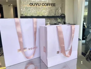 Matte White Hot-Stamped Paper Tote Bag with Pink Ribbon Handle for Bakery, Floral, and Gift Packaging